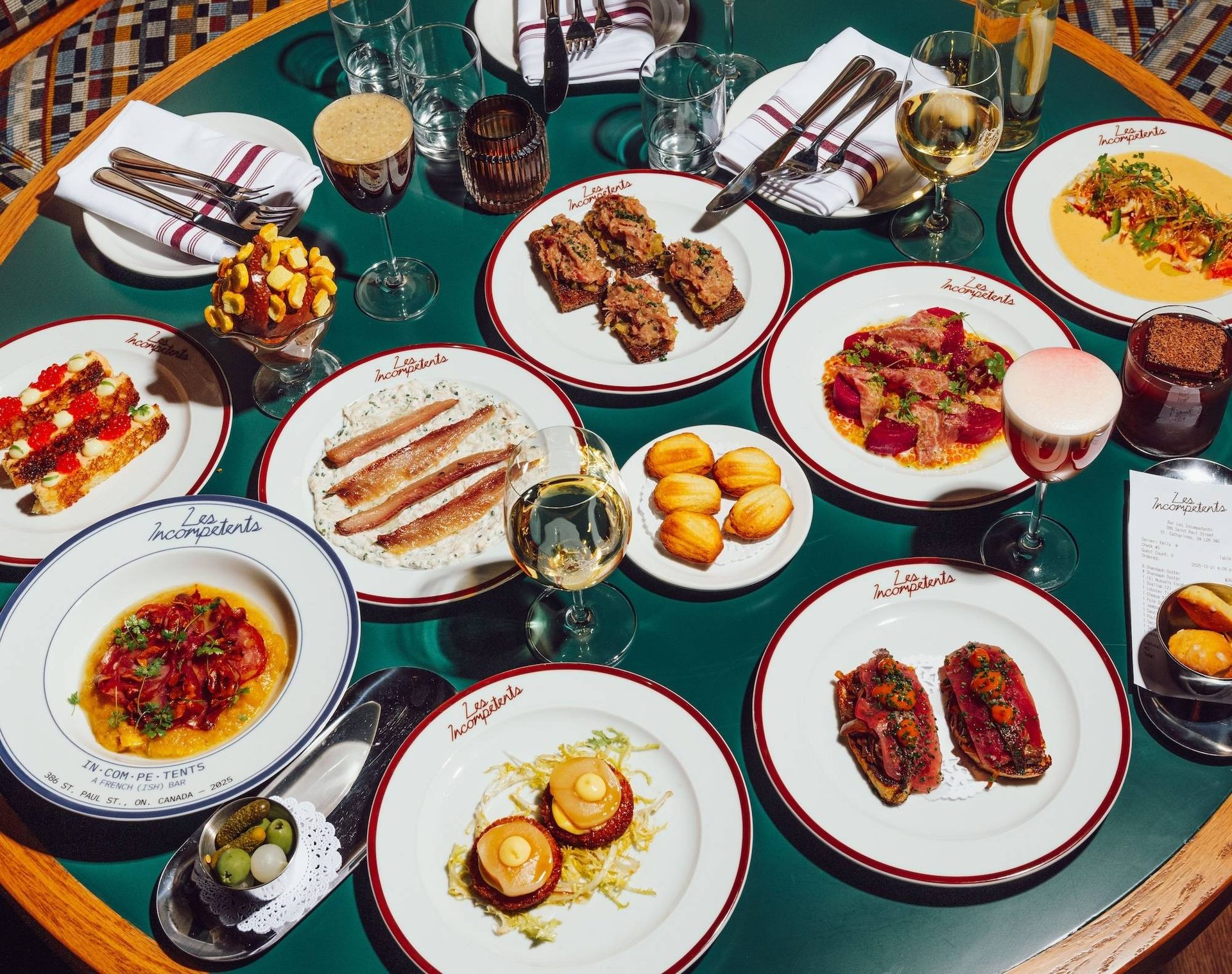 A table of small plates, wine and cocktails at Les Incompétents in St. Catharines