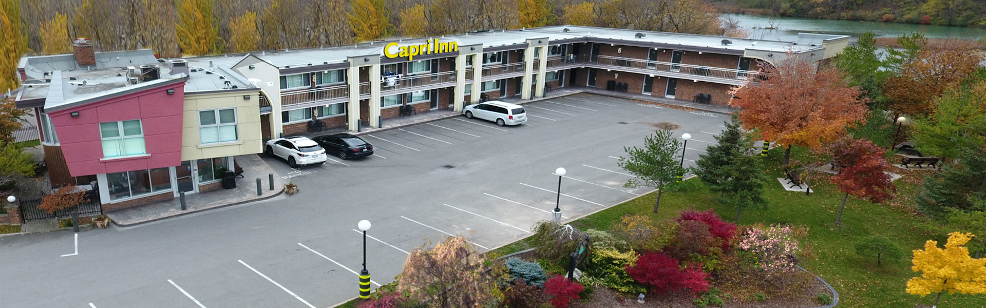 A two story hotel with a parking lot