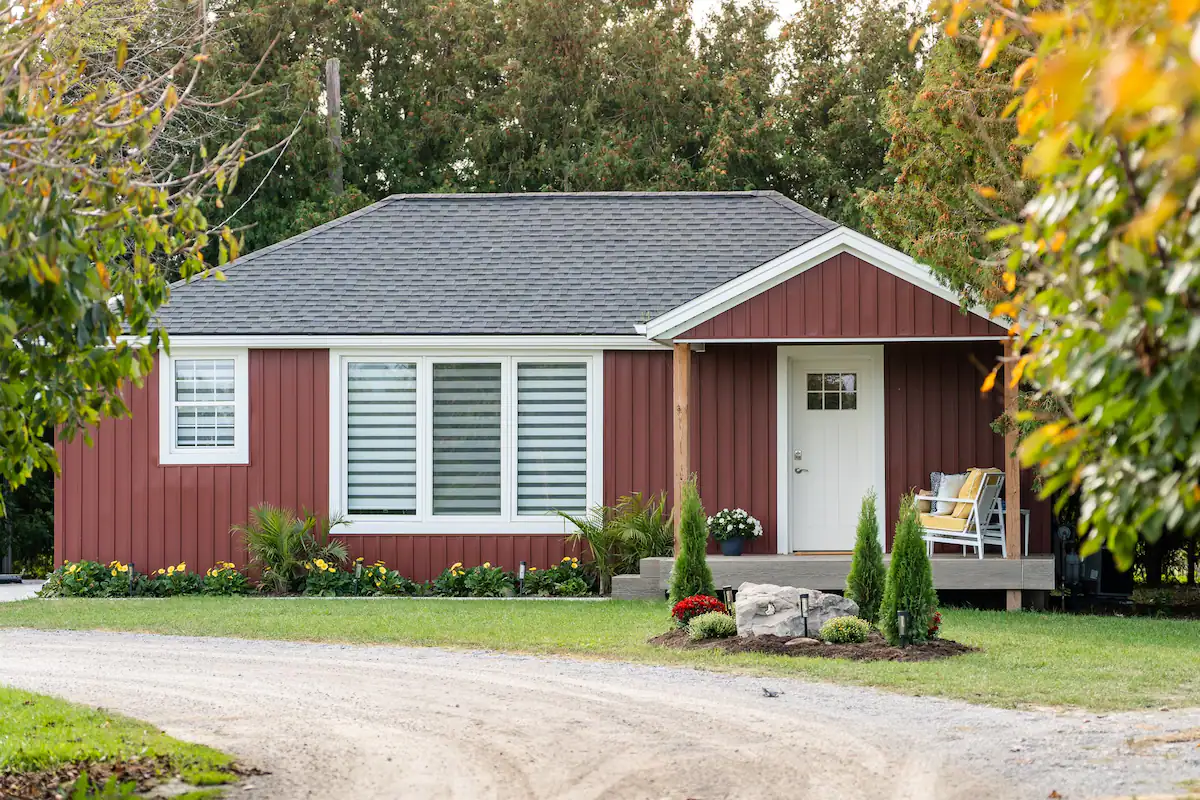 A red house with a white door and windows