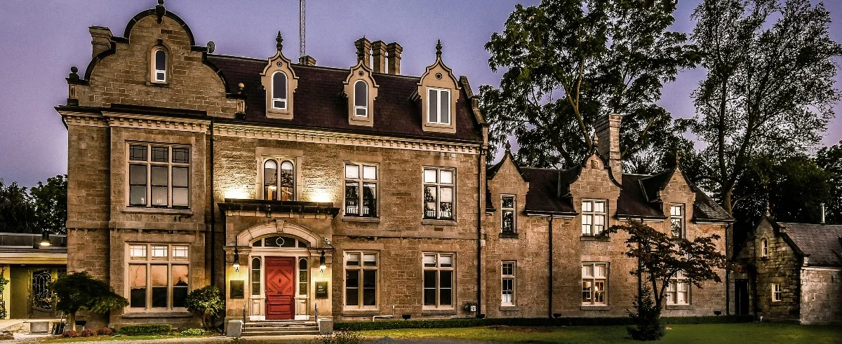 A large brick building with a red door