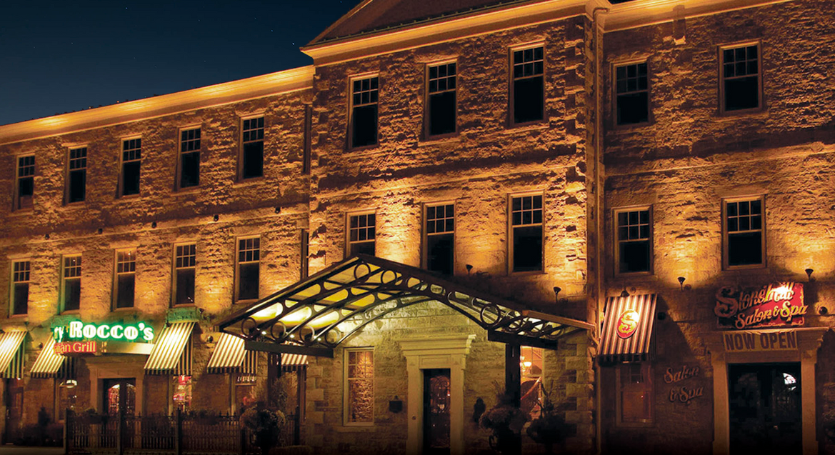 A large brick building with a lit up entrance