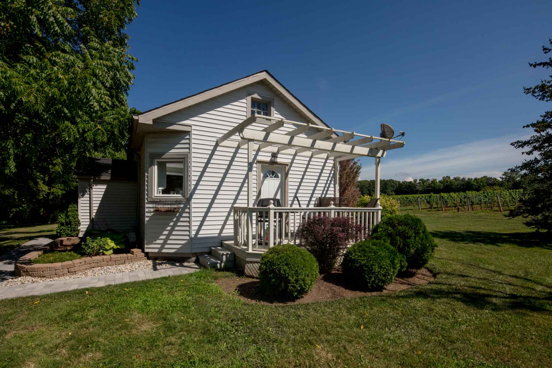 A small white house with a covered porch